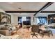The living room is full of natural light and neutral colors, with a rustic fireplace and exposed beams at 4476 Oakhill Cir, Las Vegas, NV 89121