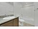 Bathroom with granite counters and a white tub at 4561 Woolcomber St, Las Vegas, NV 89115