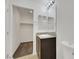 Bathroom with a granite countertop vanity, carpeted closet, and neutral walls at 4561 Woolcomber St, Las Vegas, NV 89115