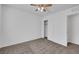 Well lit bedroom with tan carpet, ceiling fan with light, and closet with sliding doors at 4561 Woolcomber St, Las Vegas, NV 89115