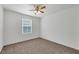 Bedroom with carpet, white walls, a window with blinds, and a ceiling fan with lights at 4561 Woolcomber St, Las Vegas, NV 89115