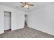 Well-lit bedroom featuring neutral carpet, closet, ceiling fan, and white walls at 4561 Woolcomber St, Las Vegas, NV 89115