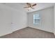 Bright bedroom featuring neutral carpet, ceiling fan, and natural light from the window at 4561 Woolcomber St, Las Vegas, NV 89115