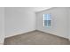 Bedroom featuring a large window, carpet, and lots of empty space at 4561 Woolcomber St, Las Vegas, NV 89115