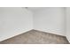 Simple bedroom with carpet, white walls, minimal lighting, and large empty walls at 4561 Woolcomber St, Las Vegas, NV 89115