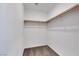 Walk-in closet with white walls and a wooden rail at 4561 Woolcomber St, Las Vegas, NV 89115