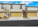 Home exterior featuring multi-car garage doors, well-kept lawns, and modern design at 4561 Woolcomber St, Las Vegas, NV 89115