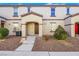 Traditional-style home featuring a covered entryway, symmetrical windows, and low-maintenance landscaping at 4561 Woolcomber St, Las Vegas, NV 89115