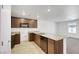 Modern kitchen featuring brown cabinets, stainless appliances, and a granite countertop island at 4561 Woolcomber St, Las Vegas, NV 89115