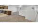 Open-concept kitchen with stainless appliances, brown cabinets, and a view of the living room at 4561 Woolcomber St, Las Vegas, NV 89115