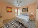 Comfortable bedroom featuring a ceiling fan, stylish art, and an exterior door at 4830 E Comanche Dr, Pahrump, NV 89061
