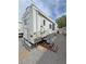 Exterior view of RV, featuring a ladder, awning, and entrance steps at 4830 E Comanche Dr, Pahrump, NV 89061