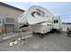 Camper parked next to a home's exterior, highlighting outdoor amenities at 4830 E Comanche Dr, Pahrump, NV 89061
