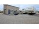 This home has an exterior door and a rolling garage door, with two campers parked on the property at 4830 E Comanche Dr, Pahrump, NV 89061