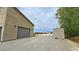 Exterior shot of garage with adjacent shipping container on a gravel lot at 4830 E Comanche Dr, Pahrump, NV 89061