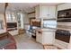 Interior shot highlighting the living area and adjacent kitchenette in the RV at 4830 E Comanche Dr, Pahrump, NV 89061