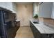 Clean kitchen with white cabinets, black appliances, and marble countertops at 4830 E Comanche Dr, Pahrump, NV 89061