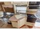 RV kitchenette with a sink, cooktop, and cabinets; a compact and functional space at 4830 E Comanche Dr, Pahrump, NV 89061