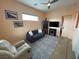 Comfortable living area featuring a gray sofa, recliner, and stylish gray rug at 4830 E Comanche Dr, Pahrump, NV 89061
