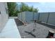Side yard featuring modern metal fencing and desert landscaping, creating a private outdoor space at 4830 E Comanche Dr, Pahrump, NV 89061