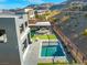 Stunning aerial view of the backyard featuring a pool, covered patio, and lush landscaping at 5231 Iron River Ct, Las Vegas, NV 89135