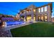 Beautiful backyard with modern house, a sparkling pool and well-maintained landscaping at 5231 Iron River Ct, Las Vegas, NV 89135