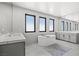 Bright bathroom with a large soaking tub, double vanity, and modern fixtures at 5231 Iron River Ct, Las Vegas, NV 89135