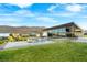 The community center features an event lawn, modern desert landscaping and mountain views at 5231 Iron River Ct, Las Vegas, NV 89135