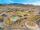 Aerial view of a desert community, featuring an elaborate community center and pool at 5231 Iron River Ct, Las Vegas, NV 89135