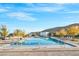 A large community pool is surrounded by lounge chairs, desert landscaping and mountain views at 5231 Iron River Ct, Las Vegas, NV 89135