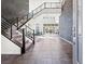 Grand foyer with open staircase, stone accent wall, and modern design elements at 5231 Iron River Ct, Las Vegas, NV 89135
