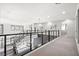 Upstairs hallway with modern railings, carpet and hardwood flooring, and plenty of natural light at 5231 Iron River Ct, Las Vegas, NV 89135