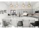 Spacious kitchen island with a marble countertop, stylish lighting and modern appliances at 5231 Iron River Ct, Las Vegas, NV 89135