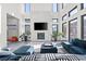 Sun-filled living room with modern fireplace, large TV, and chic, neutral decor at 5231 Iron River Ct, Las Vegas, NV 89135