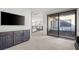 Open loft features a large screen TV, built in cabinets and a sliding glass door to a balcony at 5231 Iron River Ct, Las Vegas, NV 89135