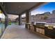 View of outdoor kitchen space with two stainless steel grills and a bar, great for entertaining at 5231 Iron River Ct, Las Vegas, NV 89135