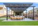 Outdoor patio area with comfortable seating, pergola, and a TV for outdoor entertainment at 5231 Iron River Ct, Las Vegas, NV 89135