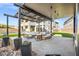 Outdoor seating area with decorative pergola, fire pit and luxurious lounge furniture at 5231 Iron River Ct, Las Vegas, NV 89135
