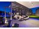 Outdoor patio with modern pergola, fire pit, and comfortable seating, perfect for evening relaxation and entertaining at 5231 Iron River Ct, Las Vegas, NV 89135