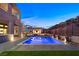 Beautiful backyard featuring a modern house, a sparkling pool and outdoor bar area at 5231 Iron River Ct, Las Vegas, NV 89135