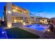 Backyard oasis features a sparkling pool, covered outdoor kitchen, and lush landscaping, ideal for luxurious outdoor living at 5231 Iron River Ct, Las Vegas, NV 89135
