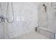 Elegant walk-in shower featuring marble accents, a built-in bench, and modern fixtures at 5231 Iron River Ct, Las Vegas, NV 89135