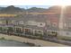 Aerial view of townhouses showcasing community layout and nearby mountain scenery at 6144 Rathbone St, Las Vegas, NV 89166