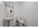 Neutral powder room featuring tile floors, pedestal sink, and updated fixtures at 6144 Rathbone St, Las Vegas, NV 89166