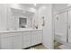 Bathroom featuring double sinks, quartz countertops, and walk-in shower with modern fixtures at 6144 Rathbone St, Las Vegas, NV 89166