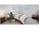 Comfortable bedroom with a large window, soft carpet, and soothing color palette at 6144 Rathbone St, Las Vegas, NV 89166
