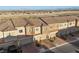 Aerial view of modern townhomes featuring well-maintained landscaping, private garages, and stylish architectural details at 6144 Rathbone St, Las Vegas, NV 89166