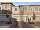 Stylish townhouse exterior with brick driveway and attached two-car garage at 6144 Rathbone St, Las Vegas, NV 89166