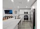 Spacious kitchen featuring stainless steel appliances, white cabinetry, a large center island, and sleek countertops at 6144 Rathbone St, Las Vegas, NV 89166
