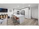 Modern kitchen features white cabinets, stainless steel appliances, and a large marble countertop island with seating at 6144 Rathbone St, Las Vegas, NV 89166